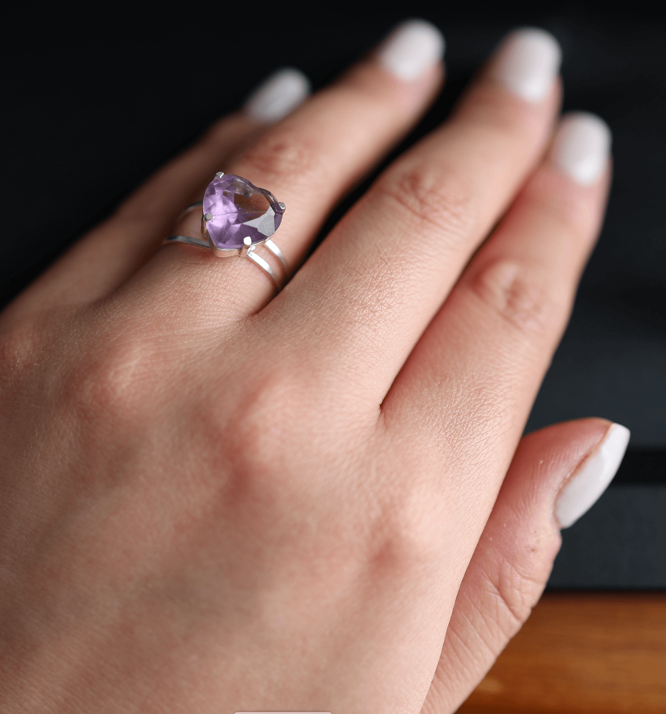 Elegant silver ring featuring a deep purple amethyst gemstone in a classic setting.